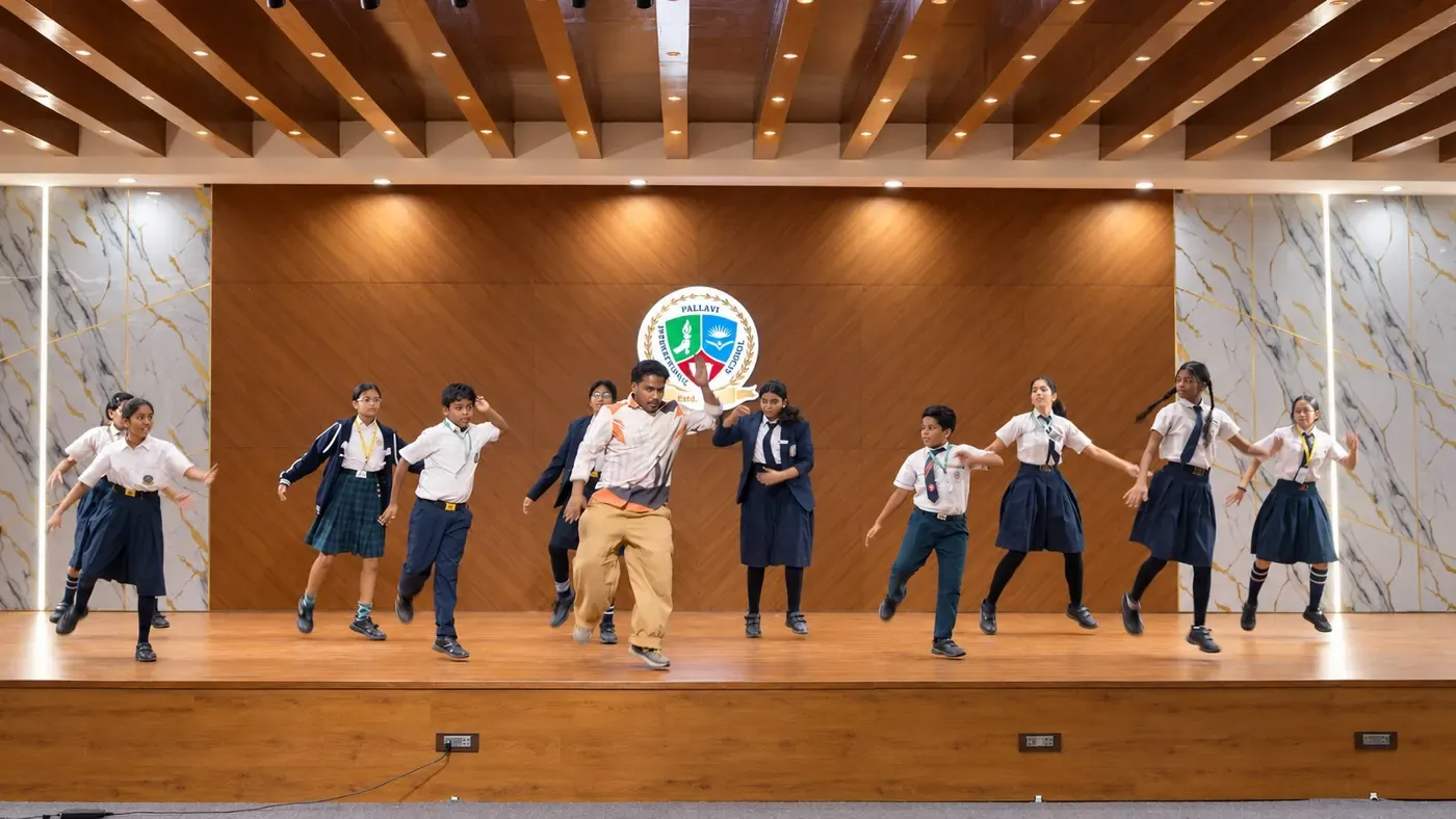 Students performing a dance on the auditorium stage